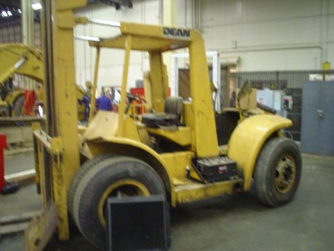 1966 International School Bus - A yellow forklift with the DEAN logo is parked indoors, with another yellow vehicle partially visible in the background.