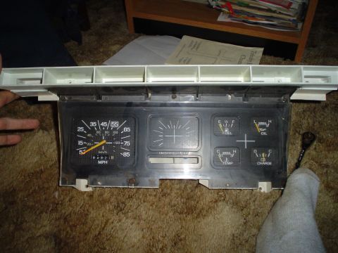 1984 Ford Bronco - A vehicle's dashboard instrument cluster is shown, multiple gauges and a speedometer.