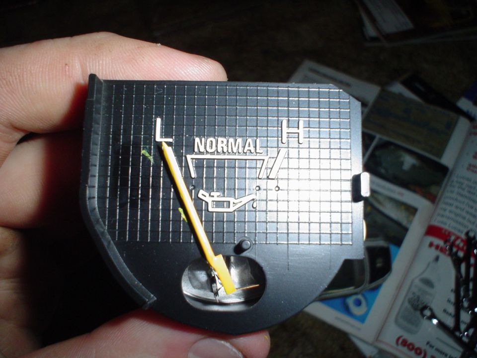 Oil pressure gauge with yellow needle pointing to low