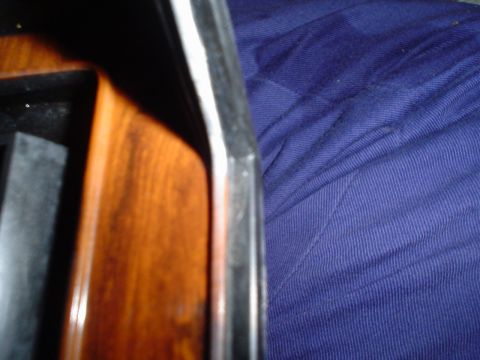 1984 Ford Bronco - Close-up view of interior wood trim and blue fabric, likely from a vehicle's dashboard or seating area.