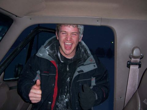 1994 Ford Bronco - A man covered in snow gives a thumbs up from inside a vehicle, likely after a winter activity.