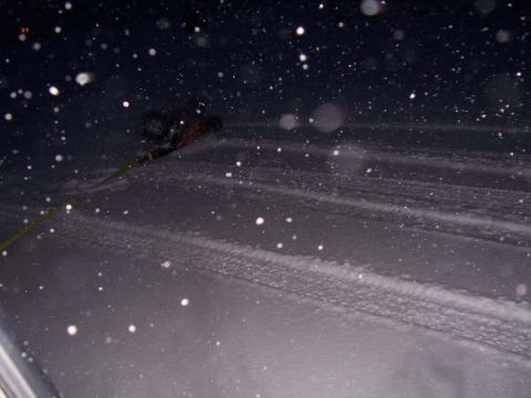 1994 Ford Bronco - A person is being pulled by a rope in a snowy environment at night.