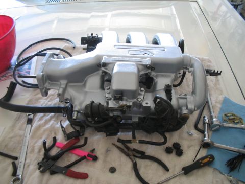 1995 Ford Probe - Engine intake manifold removed for service, with various tools laid out on a cloth.