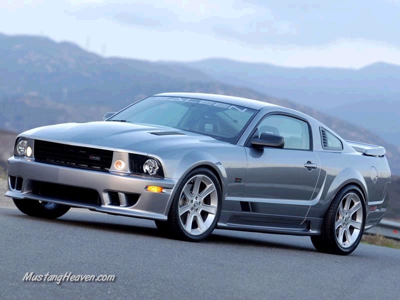 Silver coupe with a body kit and custom wheels, angled from the front left