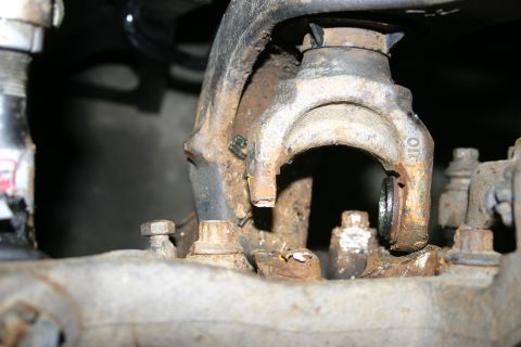 2003 Jeep TJ - Detail of corroded vehicle suspension components, showing significant rust and wear.