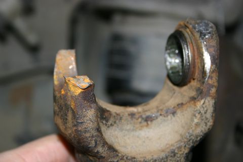 2003 Jeep TJ - This is a close-up view of a rusted U-joint yoke, showing damage to one of its ears.