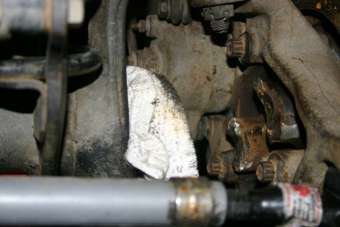2003 Jeep TJ - Close-up view of vehicle suspension components, including rusty metal and a rag.
