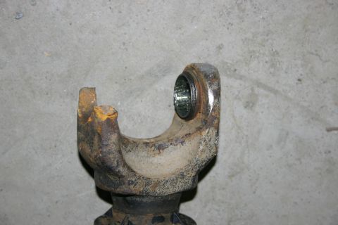 2003 Jeep TJ - A worn driveshaft U-joint shows signs of rust and grease, indicating it is a mechanical part rather than a complete vehicle.