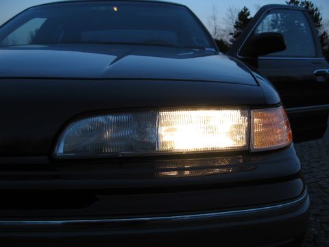 1992 Ford Crown Victoria - Front view of a 1992 Ford Crown Victoria at dusk, with the driver's door ajar.