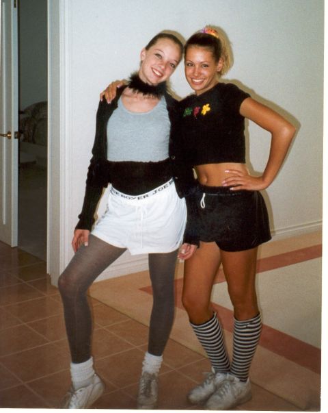 2004 Ford Taurus - Two women pose for a photo indoors, one wearing a black boa and the other with striped socks.