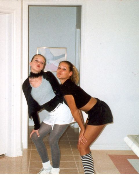 2004 Ford Taurus - Two women pose for a photo indoors, with one wearing grey tights and the other striped socks.