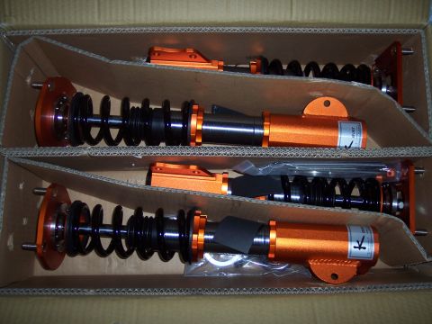 1995 Ford Probe - Coilover suspension assemblies are packaged in a cardboard box, ready for installation.