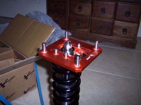 1995 Ford Probe - An orange K-Sport adjustable strut mount is shown with a black coilover spring and surrounding boxes.