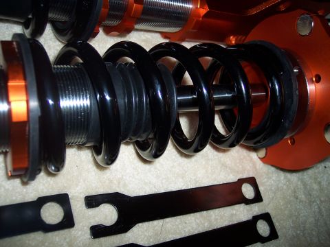 1995 Ford Probe - Close-up of adjustable coilover suspension components and their associated wrenches.