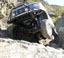 1993 Ford Bronco - A 1993 Ford Bronco navigates a steep, rocky trail, demonstrating its off-road capability.