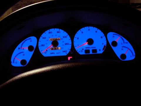 1996 Ford Probe - Dashboard gauges with blue backlighting, displaying speed, RPM, fuel, and temperature readings.