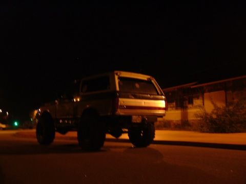 1989 Ford Bronco - This 1989 Ford Bronco is seen from the rear at night, with its distinctive body style clearly visible.