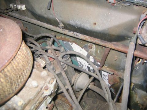 1956 Ford Thunderbird - Close-up view of a vehicle's engine bay, showing various components and signs of wear.