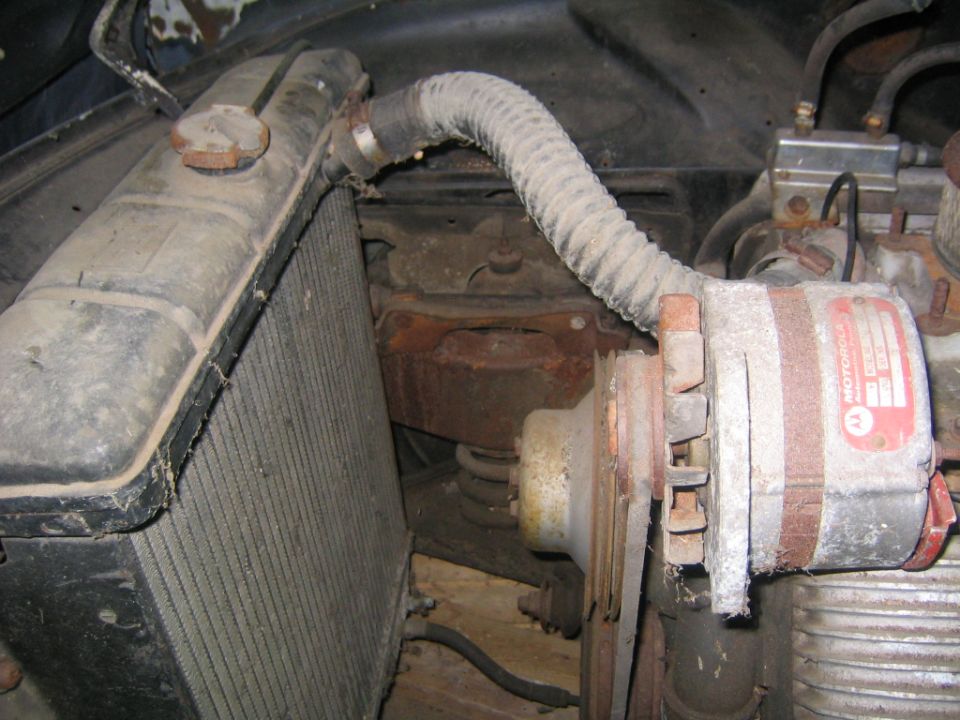 radiator, hose, and alternator in an engine bay