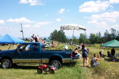 1979 Ford F-150 - Outdoor gathering with a pickup truck and several people enjoying the day.