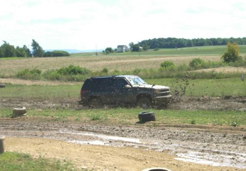 1979 Ford F-150 - SUV struggling in a mud pit during an off-road event.
