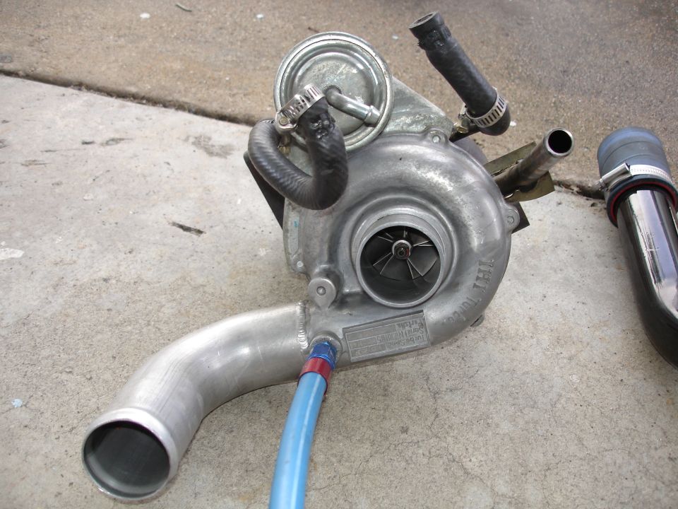 IHI turbocharger with welded aluminum outlet pipe and wastegate actuator on a concrete driveway