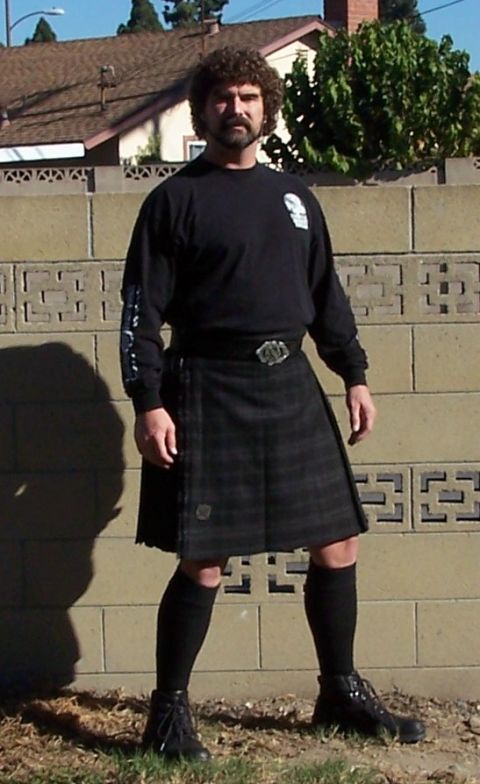 1990 Ford Bronco - Man in kilt and black long-sleeved shirt standing outdoors.
