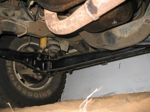 1981 Ford Bronco - The photo shows the undercarriage of a vehicle, focusing on the suspension and exhaust components.