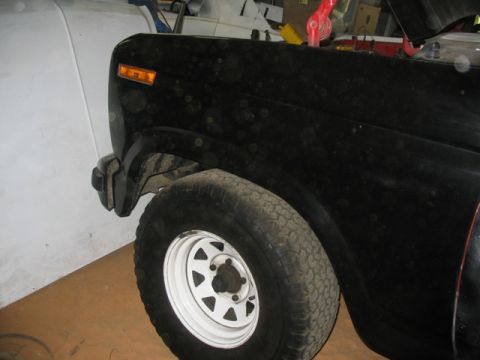 1981 Ford Bronco - Front fender and wheel of a black 1981 Ford Bronco.