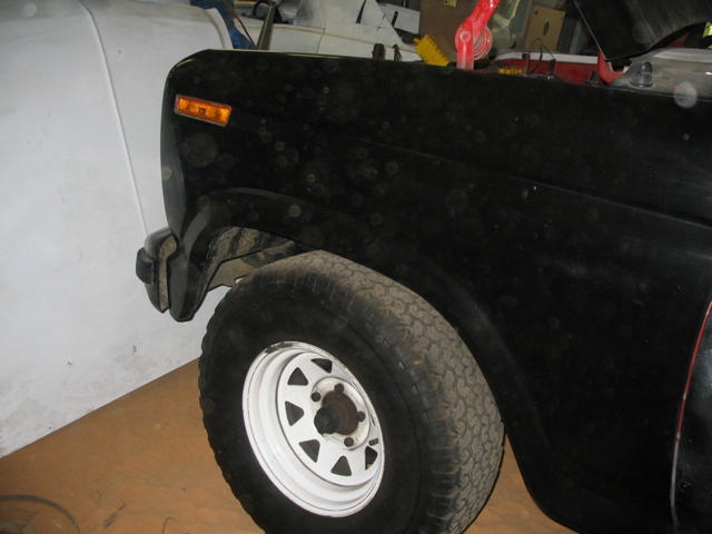 1981 Ford Bronco front fender and tire, black paint with dust spots