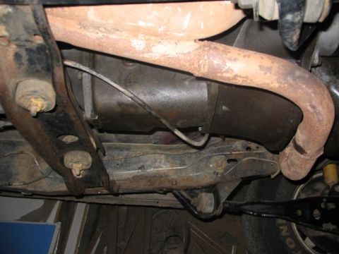 1981 Ford Bronco - Close-up of vehicle undercarriage showing exhaust system and suspension parts.