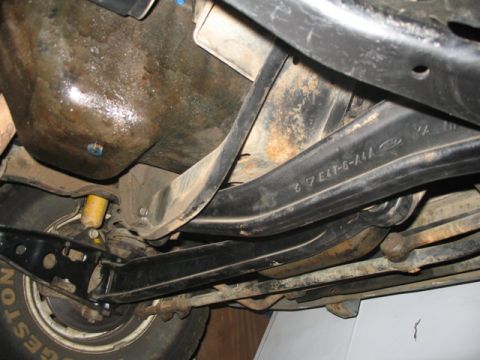 1981 Ford Bronco - The underside of the vehicle reveals suspension parts with a visible Ford logo and part number, suggesting it's a Ford product.