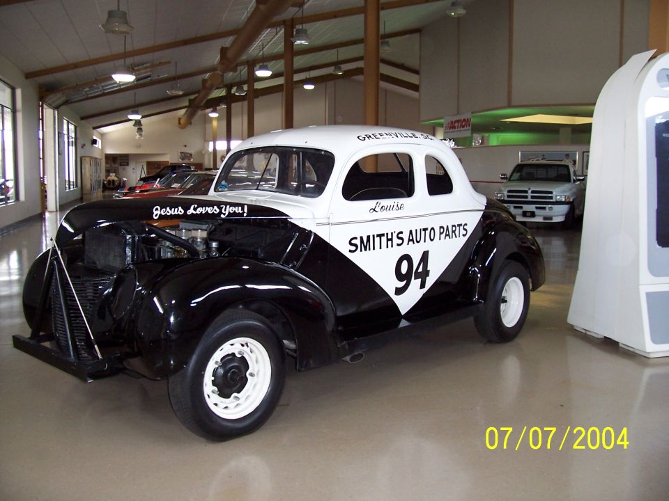 Black and white coupe race car with 'SMITH'S AUTO PARTS 94' on the side