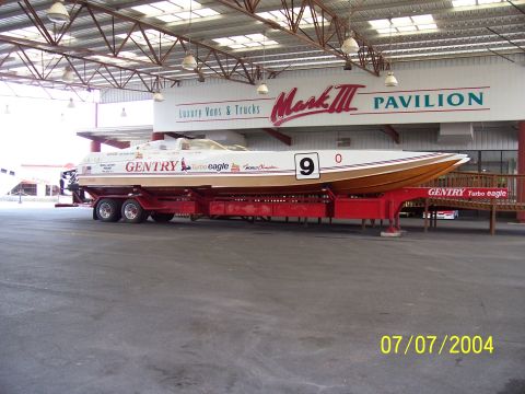 1987 Ford Bronco - A Gentry Turbo Eagle racing boat is displayed on a trailer at the Mark III Pavilion.