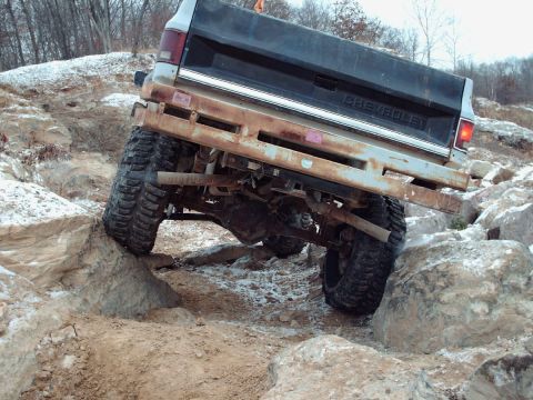 1977 Ford F-150 - This Chevrolet pickup truck is shown off-roading over large rocks.