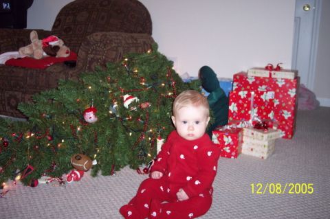 1987 Toyota 4Runner - A baby in red pajamas sits on the floor next to a decorated Christmas tree and wrapped gifts.