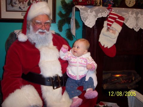 1987 Toyota 4Runner - Santa Claus poses for a photo with a baby girl on his lap.