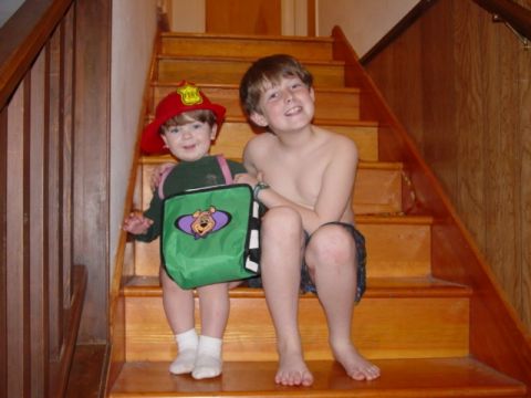 1986 Ford Bronco - Two smiling boys pose on a wooden staircase, one dressed as a firefighter.