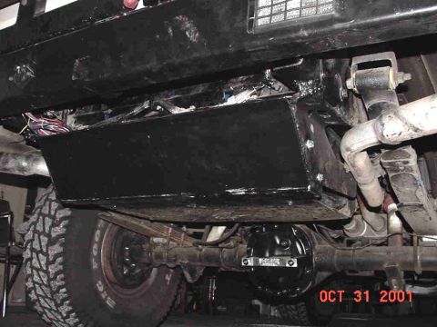 1990 Ford Bronco - The photo shows the undercarriage of a vehicle, focusing on the rear axle and suspension components.