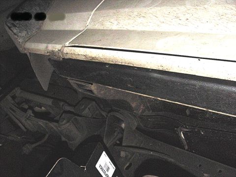1990 Ford Bronco - Undercarriage view showing frame and suspension components, with a part number tag visible.
