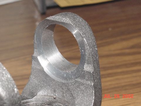 1990 Ford Bronco - Metal component with a hole, likely a vehicle part.