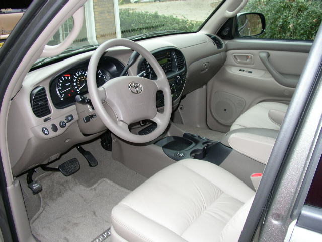 Interior of a Toyota Tundra, showing the dashboard, steering wheel with Toyota logo, and front seats