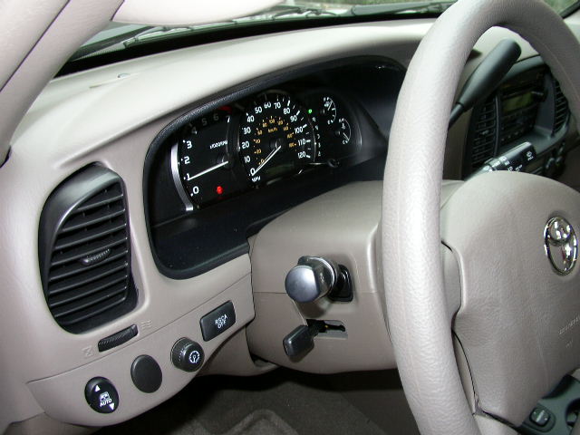 Toyota Sequoia interior showing dashboard gauges, air vents, steering wheel with Toyota logo