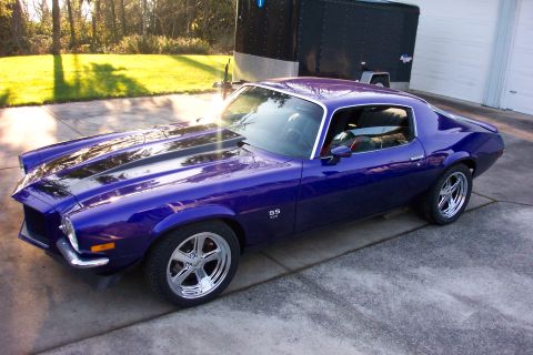 1970 Chevrolet Camaro - This purple 1970 Chevrolet Camaro SS is parked in front of a garage and trailer.