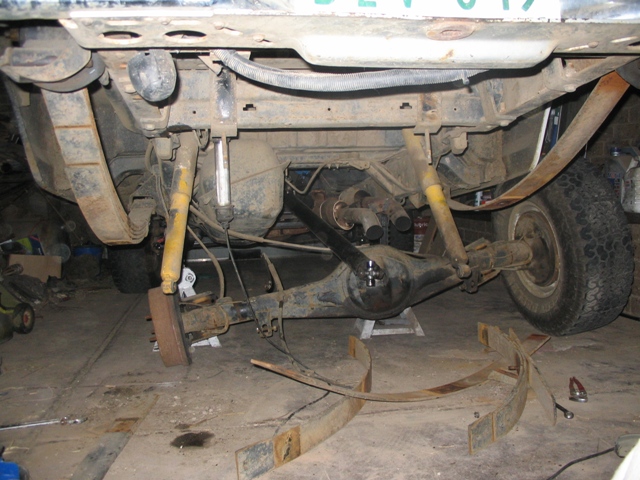Rear axle assembly of a 1981 Ford Bronco with leaf springs removed, showing shocks and differential