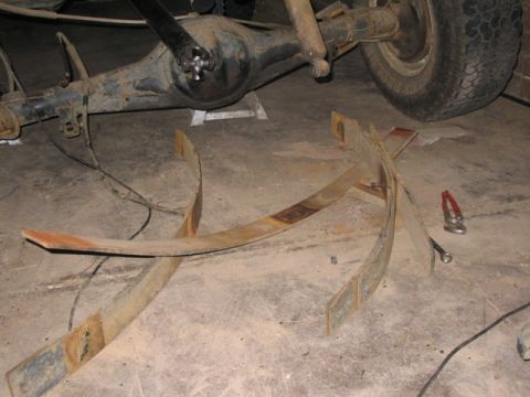 1981 Ford Bronco - The rear axle and leaf springs have been removed, suggesting a modification or repair is underway.