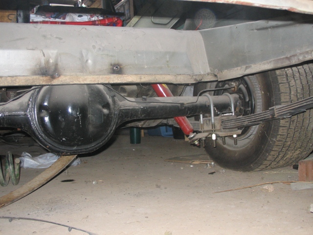 Rear axle assembly with red shock absorbers and leaf springs