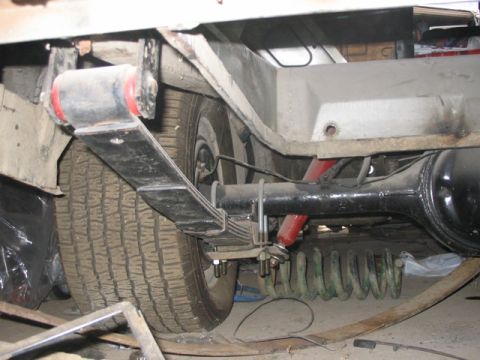 1981 Ford Bronco - Close-up view of a vehicle's rear suspension system, focusing on the leaf springs.