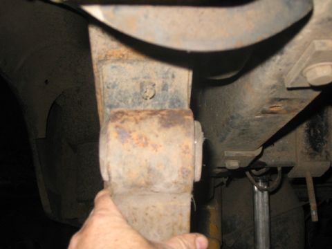 1981 Ford Bronco - Close-up of heavily rusted suspension components, including a leaf spring.
