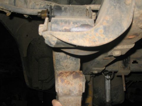 1981 Ford Bronco - Close-up view of the rear suspension leaf spring and shackle assembly.